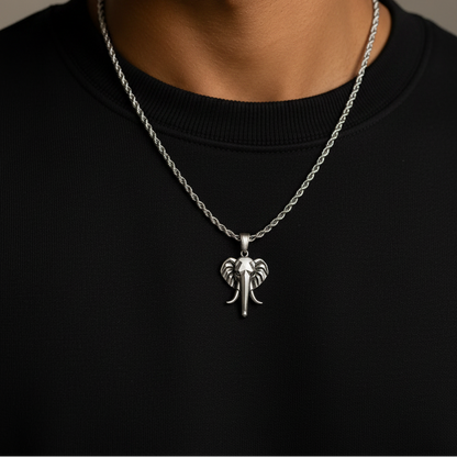Man wearing a silver necklace with an elephant pendant on a neutral background
